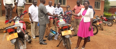 Chief Administrative Officer/Apac, Canon George Adoko hands over the key to Akech Caroline