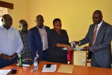CAOS Michael Wanje and Stella Abyeto during handover ceremony at Planning Unkit Board Room