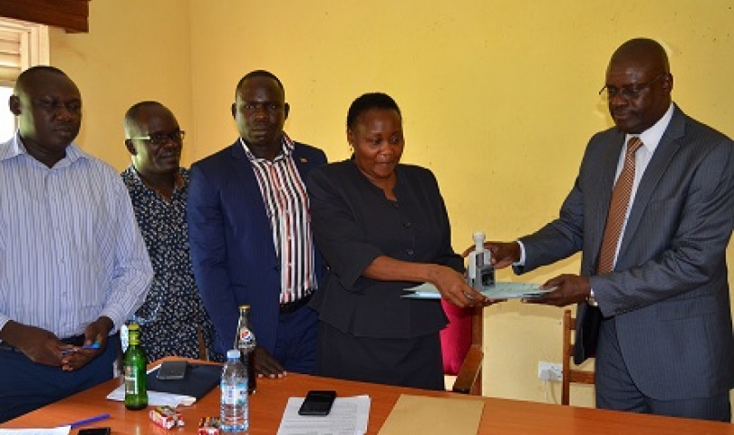 CAOS Michael Wanje and Stella Abyeto during handover ceremony at Planning Unkit Board Room